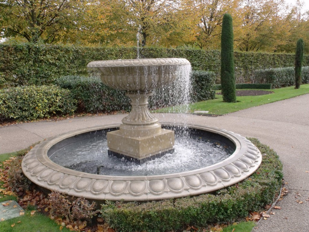 outdoor water fountain with pond
